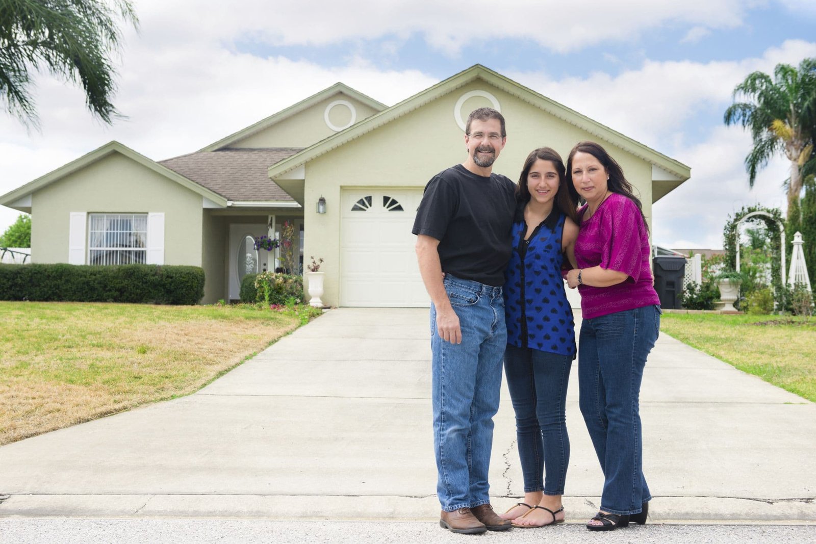 Florida family standing in a renovated living space, smiling and relaxed